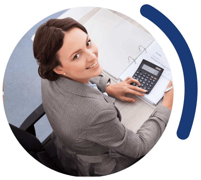 A woman sitting at a table with a calculator.