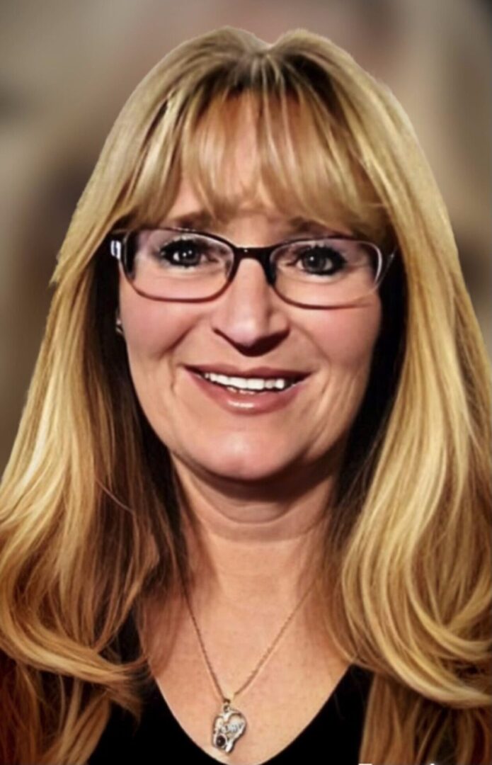 A woman with glasses and long blonde hair.